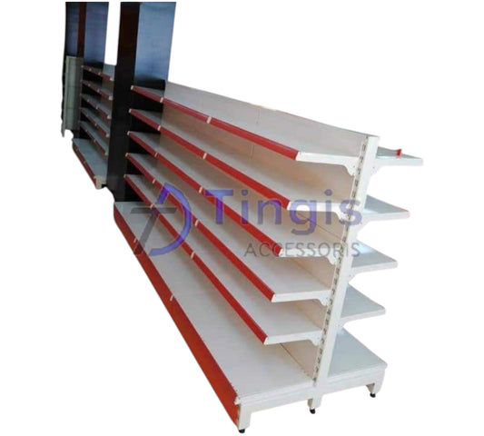 A double-sided white metal shop shelf unit with several red-edged shelves, taken at an angle so you can see both sides.
